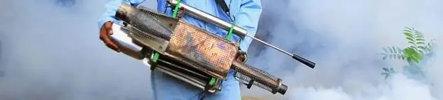 Fumigation technician using a fogger for deep pest treatment in Toledo, OH